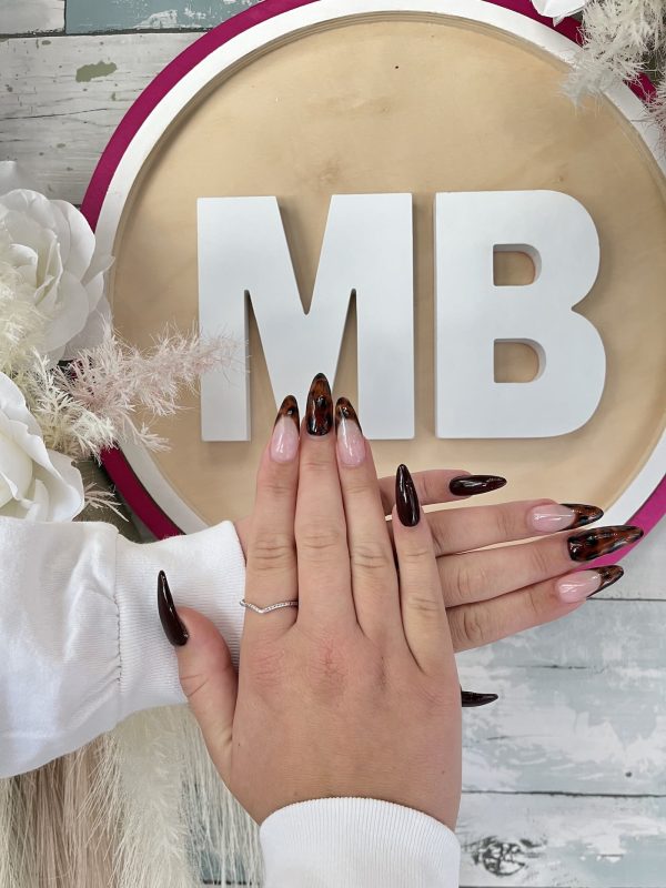 Dark brown tortoiseshell pattern on long stiletto almond nails by ManiBliss nail salon Alpharetta GA